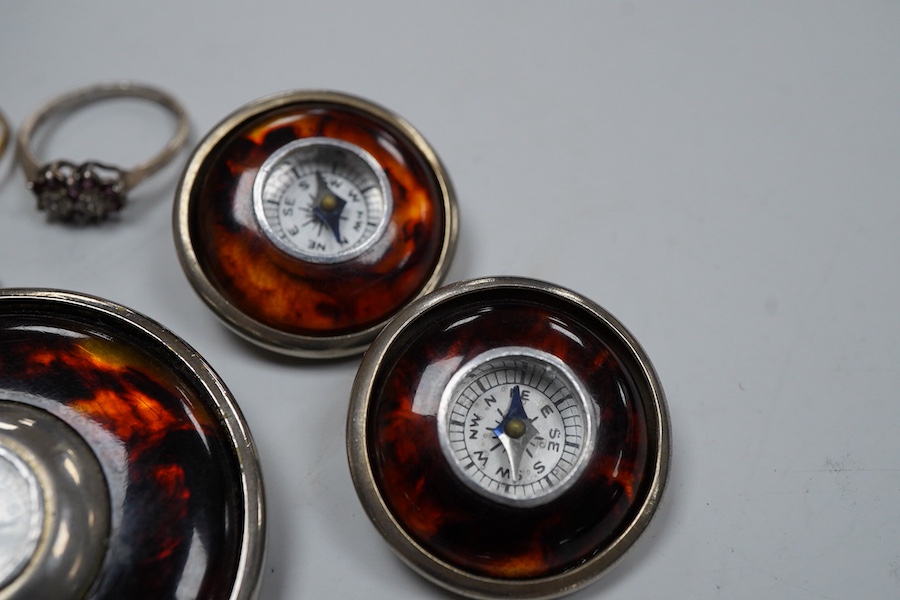 A collection of jewels, comprising: a coated topaz cluster ring in gold, stamped 9ct; a synthetic sapphire and colourless paste cluster ring in gold, stamped 9CT; an amethyst and colourless paste ring in silver, British